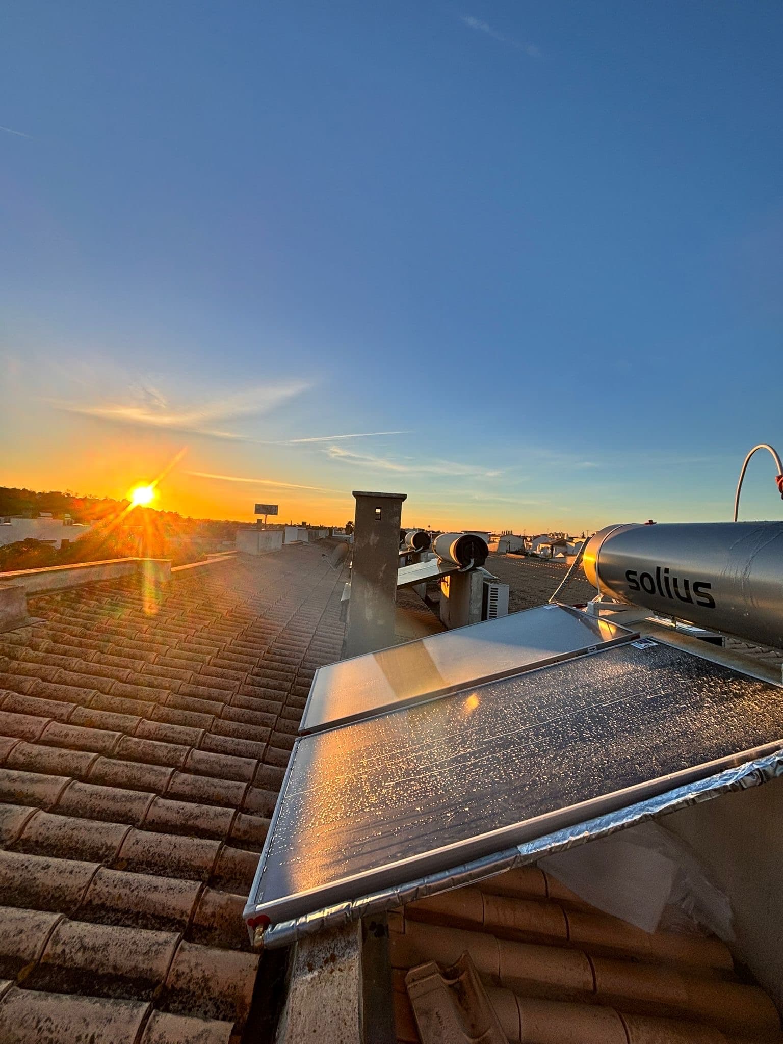 Painel solar térmico Solius instalado numa cobertura ao pôr do sol